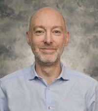 An Operator Walks Up To A Machine Tool
